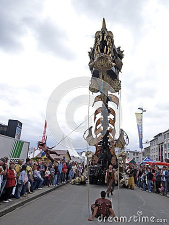 Giant mechanical smoking dragon with acrobats Editorial Stock Photo