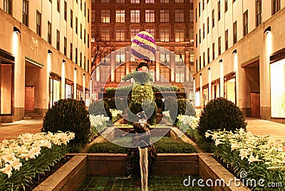 giant revolving Easter Bunny topiary displayed at Rockefeller Center Channel Gardens at night Editorial Stock Photo