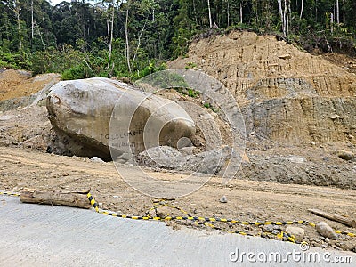 Giant rock beside road after landfall forest Stock Photo