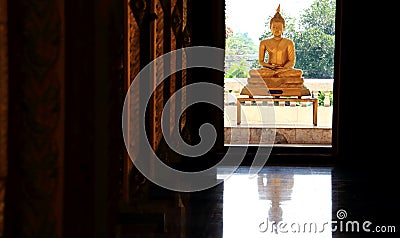 a giant sitting statue Buddha images behind the doors in Thai temples Stock Photo