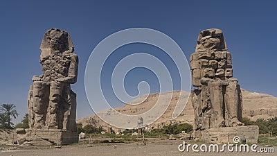 Giant stone sculptures of the Colossi of Memnon in Egypt. Stock Photo