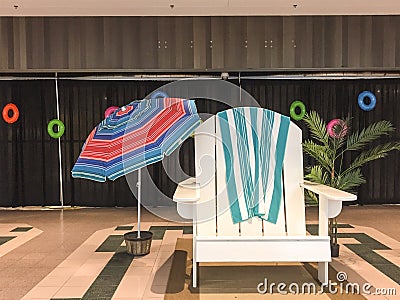 Giant Summer Beach Chair and Umbrella Scene in Shopping Mall Stock Photo