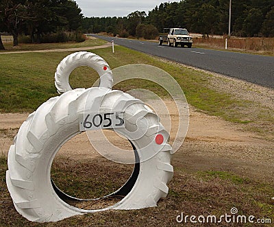 Giant tractor tyres make an impressive gateway to a country Victoria property Stock Photo
