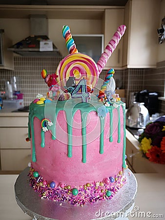 Giant trolls 4th birthday cake girls green pink sweets Stock Photo