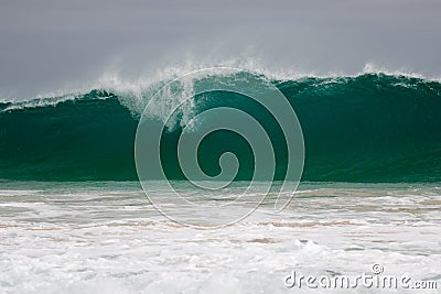 Giant wave hits the shore Stock Photo