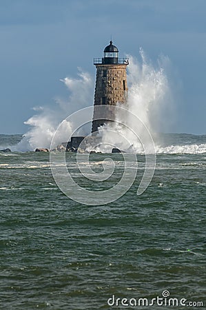 Giant Waves Surround Stone Lighthouse in Maine Stock Photo