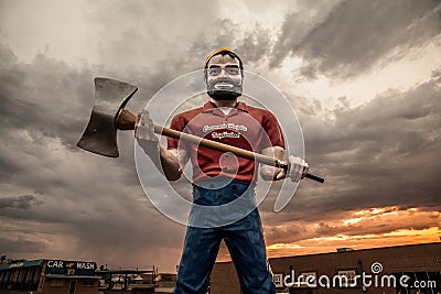 Giant worker under a cloudy sky Editorial Stock Photo