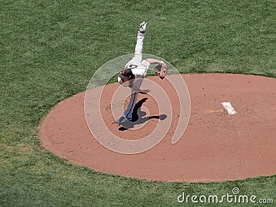 Giants two time Cy Young award winner Tim Lincecum finishes throwing a pitch by lifting back leg high into the air Editorial Stock Photo