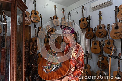 GIANYAR,BALI/INDONESIA-MAY 30 2019: I Wayan Tuges, the owner of the Tuges and Blueberry carving guitar in Guwang, Gianyar Bali, Editorial Stock Photo