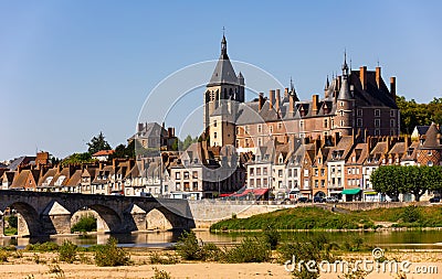 Gien cityscape on bank of Loire with medieval castle and arched bridge Stock Photo