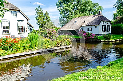 Giethoorn, Netherlands: Landscape view of famous Giethoorn village with canals and rustic thatched roof houses. The beautiful Editorial Stock Photo