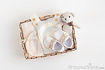 Gift basket with gender neutral baby garment and accessories. Care box of organic newborn cotton clothes Stock Photo