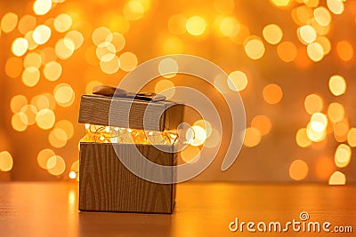 Gift on blurry New Year lights background Stock Photo