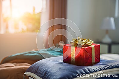 Gift box in bedroom. Holiday and anniversary day concept. Birthday and Valentines day surprise concept. Chirstmas and New year th Stock Photo