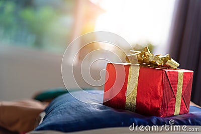 Gift box in bedroom. Holiday and anniversary day concept. Birthday and Valentines day surprise concept. Chirstmas and New year th Stock Photo