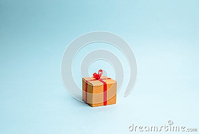 Gift box on blue background. Minimalism. The approach of the New Year holidays or birthday. Sale of gifts, special promotion Stock Photo