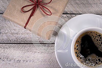 Gift box and coffee cup on wooden background Stock Photo