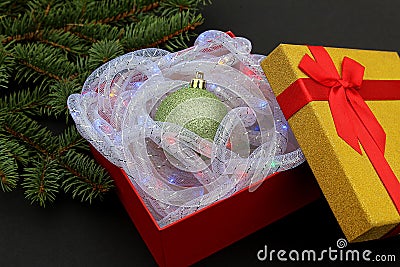 The gift box contains a Christmas present, a Christmas tree toy. Stock Photo