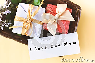 Gift box with I love you mom text on card Stock Photo