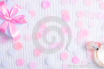 Gift box and perfume on white background with confetti. Stock Photo