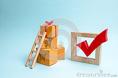 A gift box on a pile of boxes and a red check mark. The concept of finding the perfect gift. Shopping list. Sale, big discounts Stock Photo