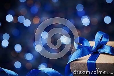 Gift box or present and christmas balls against blue bokeh background. Magic holiday greeting card. Stock Photo