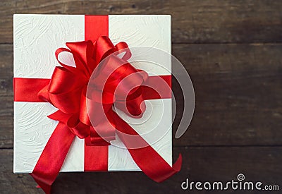 Gift box with red bow on wood table Stock Photo