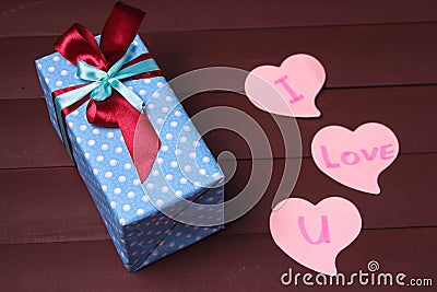 Gift box and red heart with wooden text for I LOVE YOU on wood table background. Stock Photo