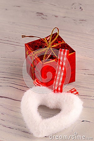 Gift box with ribbon and heart on wooden background for Valentines Day. Stock Photo