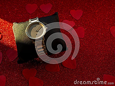 Gift box with silver watch is on red heart paper background Editorial Stock Photo