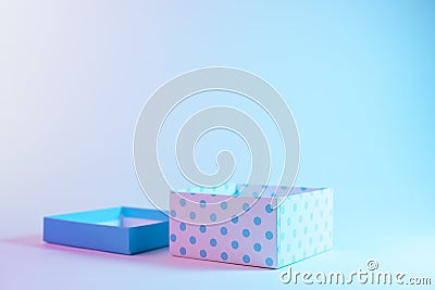 Gift box in vibrant bold gradient holographic colors. Christmas and New Year minimal art concept Stock Photo