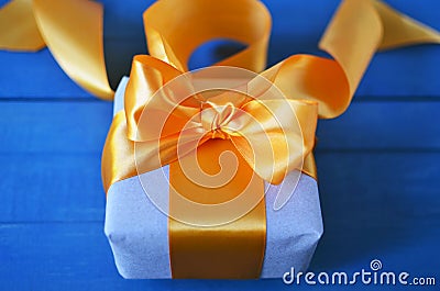 Gift box wrapped with craft paper and bow on neutral background with boke. Holiday concept. Stock Photo