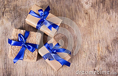 Gift boxes with blue ribbons on the old wooden background. Copy space. Stock Photo