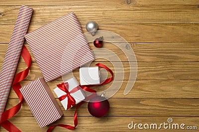 Gift boxes, paper's rools and decorations on wooden background, top view Stock Photo