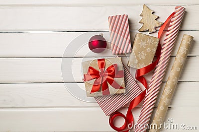 Gift boxes, paper's rools and decorations on wooden background, top view Stock Photo