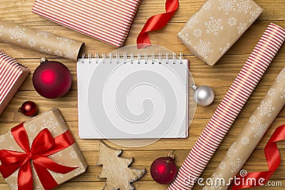 Gift boxes, paper's rools and decorations on wooden background, top view Stock Photo