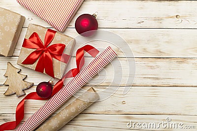 Gift boxes, paper's rools and decorations on wooden background, top view Stock Photo