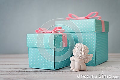 Gift boxes with statuette of angel Stock Photo