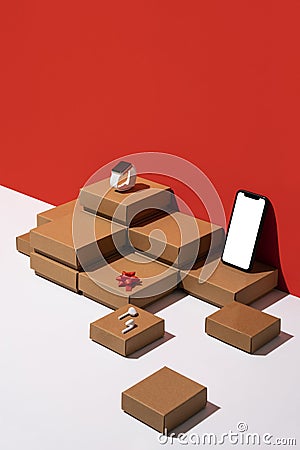 Gift boxes and technologic devices organized neatly with smartphone mockup Stock Photo