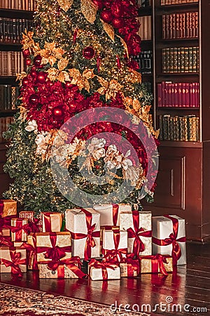 Gift boxes and traditional Christmas tree, wrapped presents and decor in colonial style as holiday home decoration Stock Photo