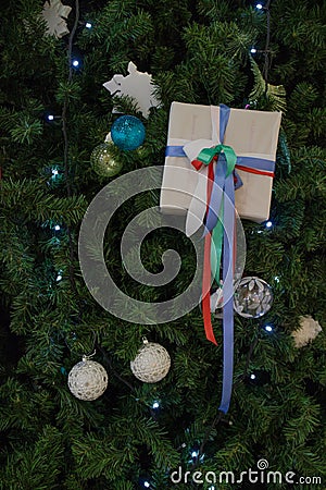 Gift on the branches of the Christmas tree Stock Photo