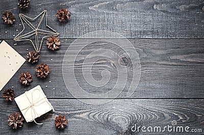 Gift, card, pine cones and cinnamonin on the dark wooden texture Stock Photo