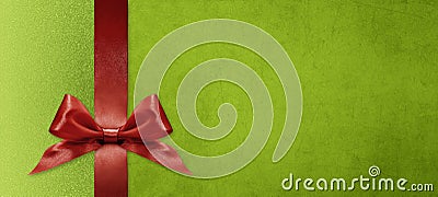 Gift card wishes merry christmas background with red ribbon bow on green shiny vibrant color texture template with blank copy Stock Photo