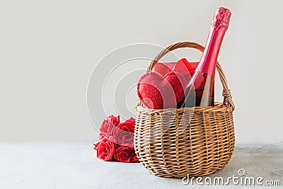 Gift hamper, bouquet of red roses,heart, bottle of champagne on white. Valentines day card. Romantic gift Stock Photo