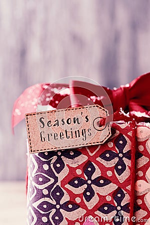 Gift with a label with the text seasons greetings Stock Photo