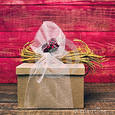 Gift ornamented with flowers, natural fibers and tulle Stock Photo