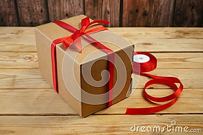 Gift parcel or mail box with ribbon red bow, brown carton parcel, surprise Stock Photo