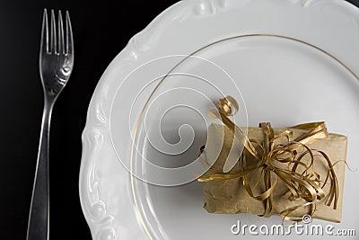 Dinner Setting with Gift. Suprize eating or gift dinner concept Stock Photo