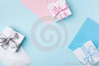 Gift or present box and colorful envelopes on blue table top view. Greeting for holiday. Flat lay. Stock Photo