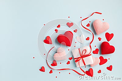Gift or present box decorated with mixed red hearts for Valentine or Mother day on pastel blue background top view Stock Photo